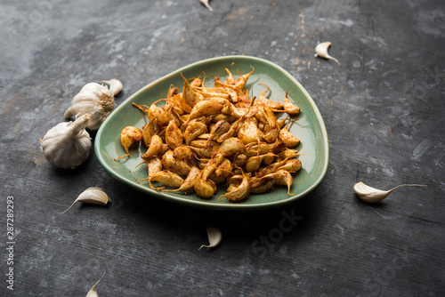 Garlic Fry or Tala Hua Lahsun in hindi, is a popular side dish or snacks from maharashtra, India photo