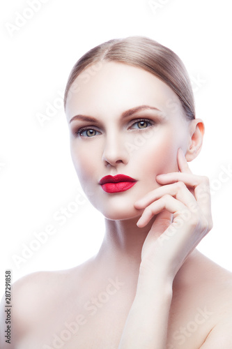 Cute sexy beautiful young model woman with red lips make-up  perfect healthy skin touching face. Blonde beauty girl studio portrait. White background