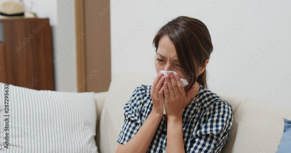 Woman suffer from influenza, sneeze at home Woman suffer from influenza, sneeze at home