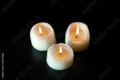 mourning candles on black background