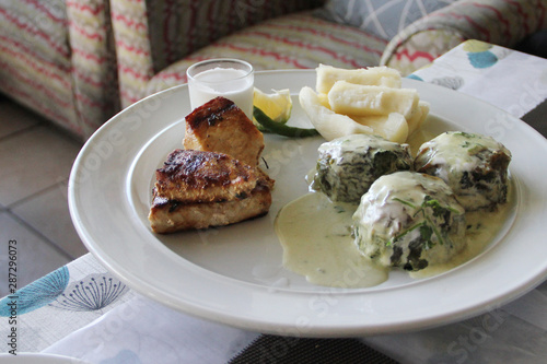 Traditional Fijian food: Rourou (taro leaves soaked in coconut milk) Balls with grilled fish and steamed cassava.