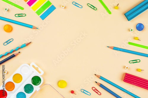 School accessories on a yellow background. Pastel colored.