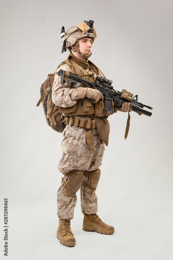 Portrait of a young American US Marine Corps soldier over grey background Portrait of a young American US Marine Corps soldier over grey background