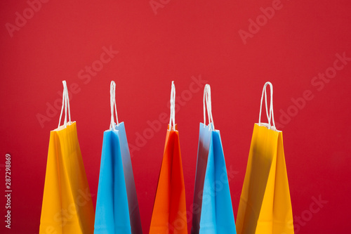 Arrangement of shopping bags on red background