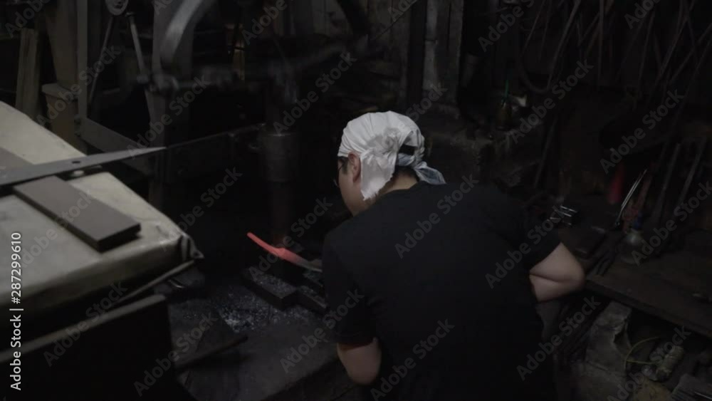 Blacksmith forges while mill powerfully pounds Blacksmith forges while mill powerfully pounds