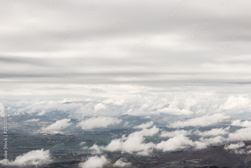 View from above of Umbria valley, with cloudscape both above and below