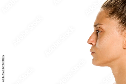 Profile of young woman without makeup on white background