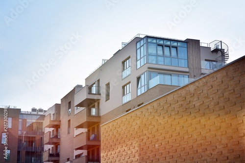 Modern apartment buildings on a sunny day with a blue sky. Facade of a modern apartment building.Glass surface with sunlight.