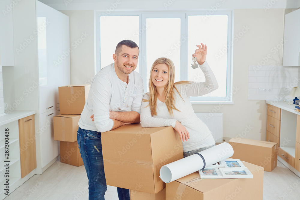 Happy family unpacking boxes at new home Happy family unpacking boxes at new home