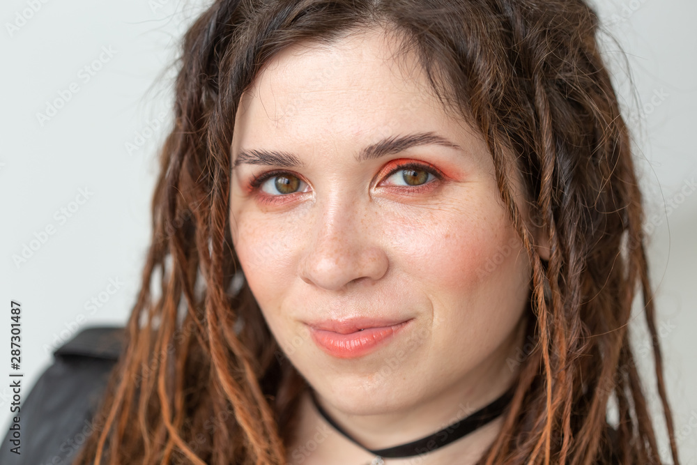 Fashion and beauty concept - portrait of young stylish woman with dreadlocks Fashion and beauty concept - portrait of young stylish woman with dreadlocks