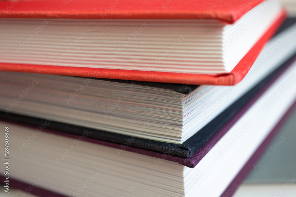 Close-up of book stack. Several colorful books with selective focus Close-up of book stack. Several colorful books with selective focus