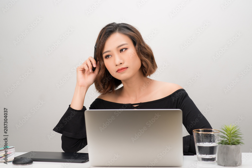 Asian girl graphic designer thinking idea for a new project, freelancer thinking idea for a new project in selective focus.