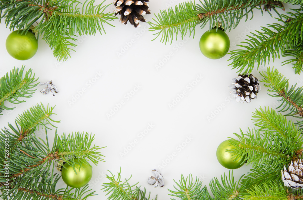 Christmas frame mockup. Pine cones, fir branches and green Christmas balls on white background. Flat lay Christmas frame mockup. Pine cones, fir branches and green Christmas balls on white background. Flat lay