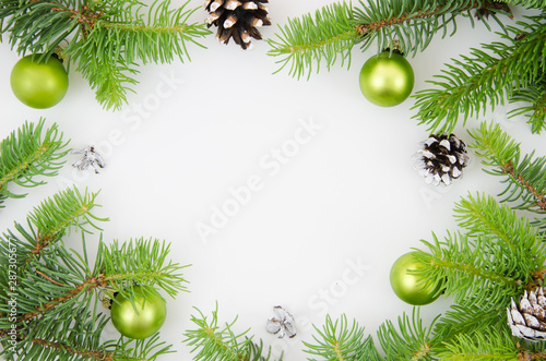 Christmas frame mockup. Pine cones  fir branches and green Christmas balls on white background. Flat lay
