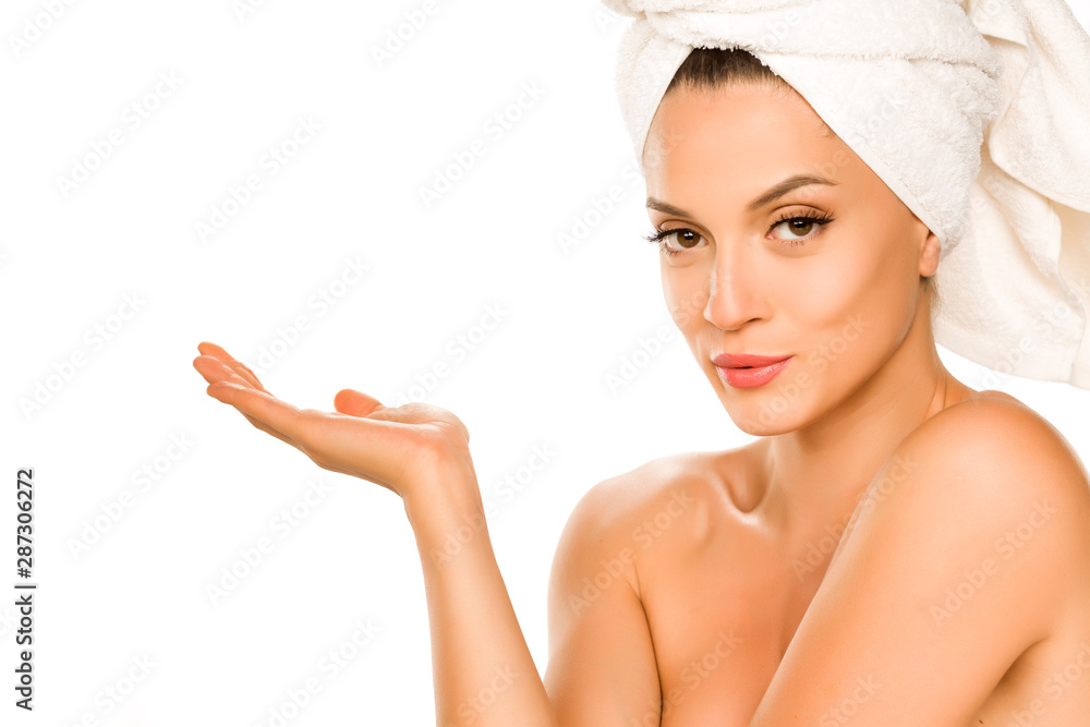 Young beautiful advertizing woman with towel on her head on white background Young beautiful advertizing woman with towel on her head on white background