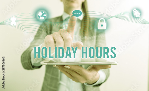 Fototapeta Naklejka Na Ścianę i Meble -  Conceptual hand writing showing Holiday Hours. Concept meaning employee receives twice their normal pay for all hours Female human wear formal work suit presenting smart device