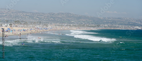 Crowd of beachgoers and strong surf at Newport Beach
