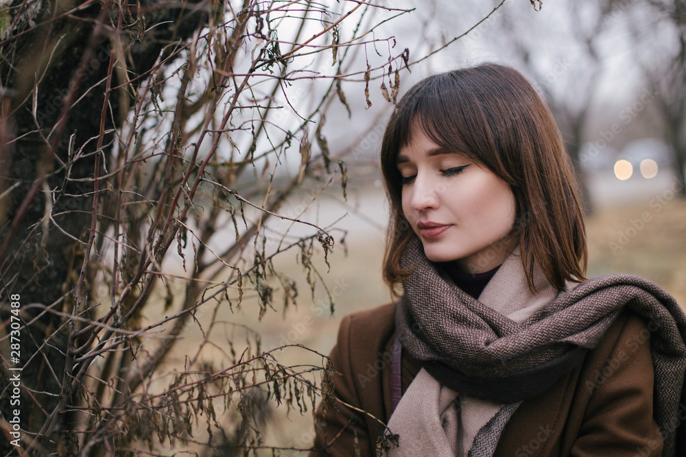 Woman in brown stylish cashmere posing on autumn background. Woman in brown stylish cashmere posing on autumn background.