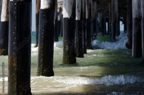 Long row of poles under Newport Beach Pier photo