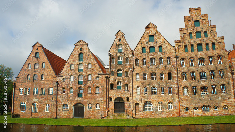 Scenic view of Salzspeicher brick warehouses in old town, beautiful architecture, sunny day, Lubeck, Germany