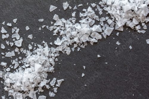 Cypriot sea salt flakes on black background - Overhead photo