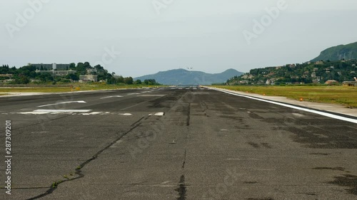 Passenger aircraft flying in the sky. Airplane landing on the runway at airport. Greece. 4K