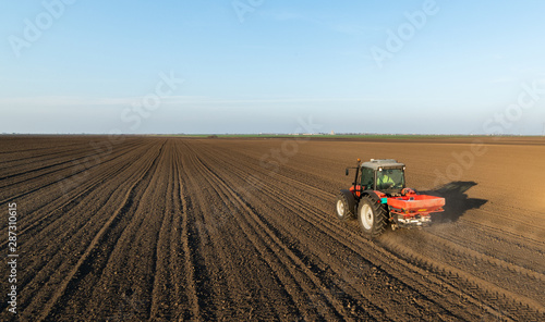 Farmer fertilizing arable land