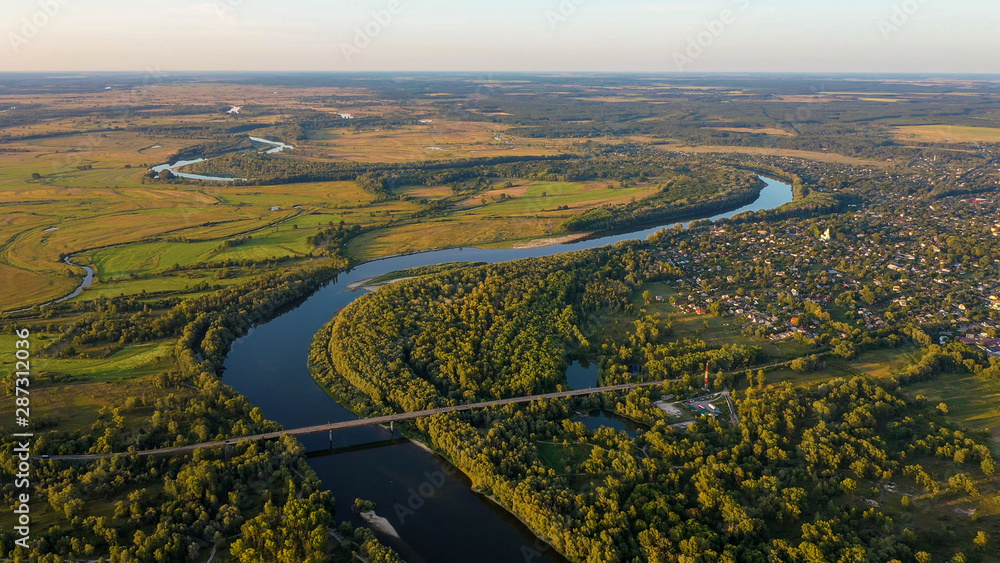 Aerial view of river flood. Beautiful flooded meadow. Flying above beautiful Desna river when the river is full of water at spring at National Nature Park in Chernihiv Oblast, Ukraine.