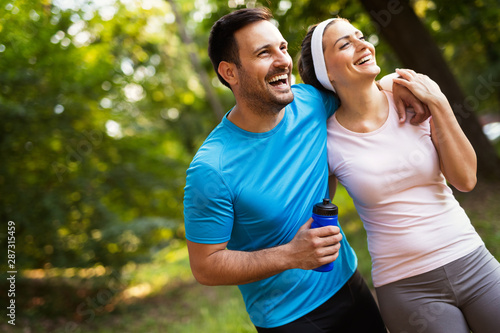 Happy couple jogging and running outdoors in nature