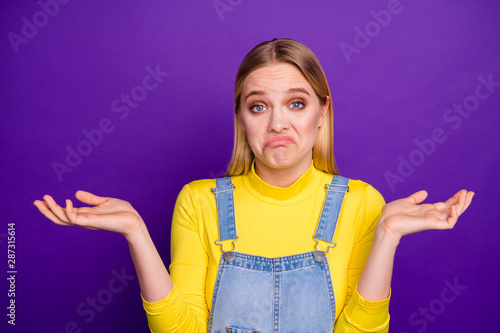 Canvas Print Portrait of indifferent person shrugging her shoulders wearing yellow turtleneck