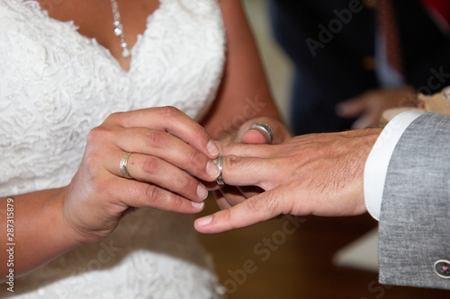bride and groom hands of newlyweds with wedding rings in ceremony