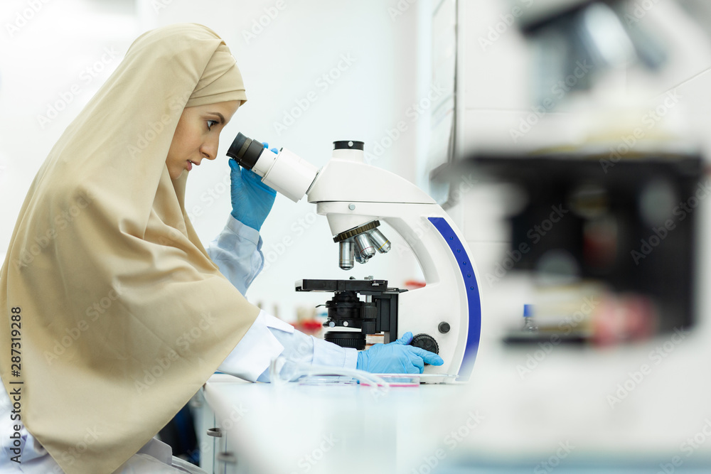 Concentrated young medical worker doing DNA analysis Concentrated young medical worker doing DNA analysis