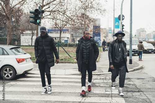 Three young african men crossing the street together