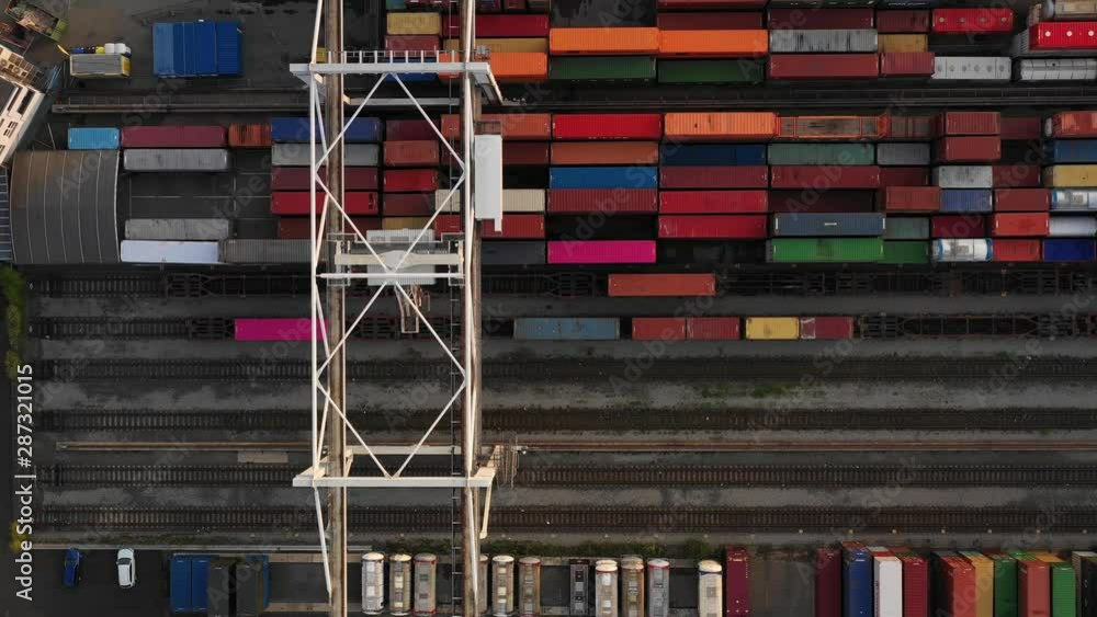 Flying above industrial railroad station with cargo trains and freight ...