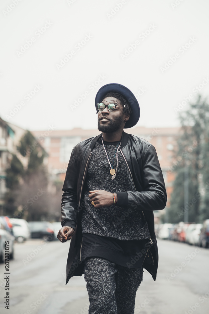 young bearded african man outdoors walking looking away young bearded african man outdoors walking looking away