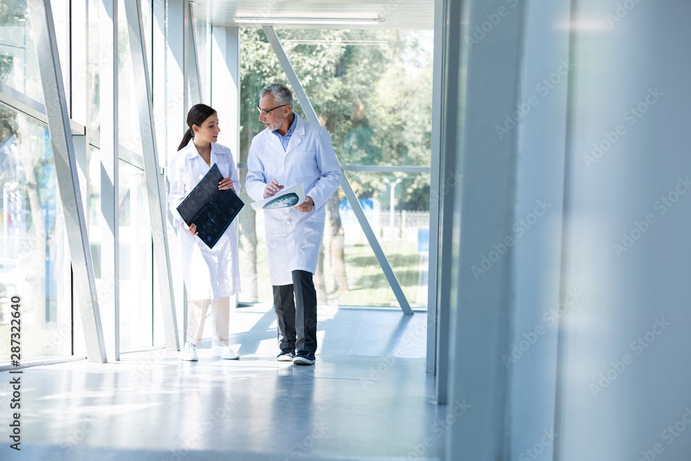 Fototapeta premium Professional medical worker talking to his assistant