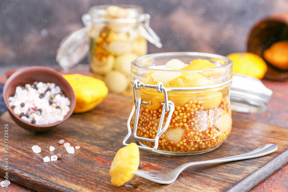 Jar with canned squashes on wooden board Jar with canned squashes on wooden board