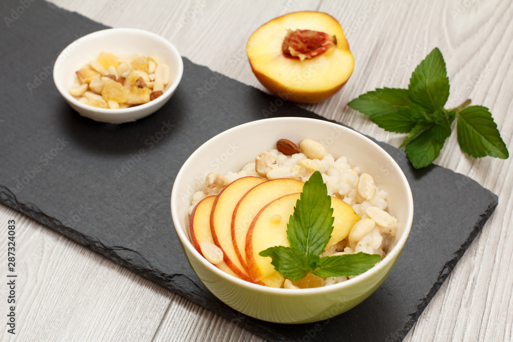 Sorghum salad with nuts and fresh peach on stone board. Sorghum salad with nuts and fresh peach on stone board.