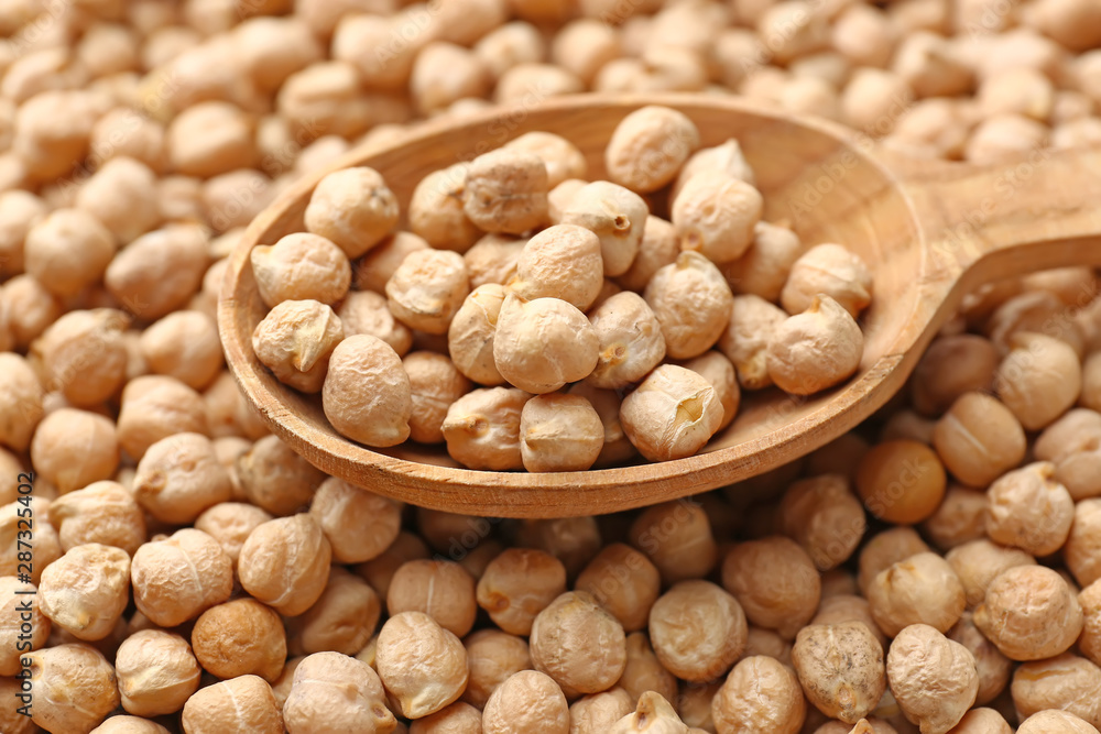 Spoon on many raw chickpea, closeup Spoon on many raw chickpea, closeup