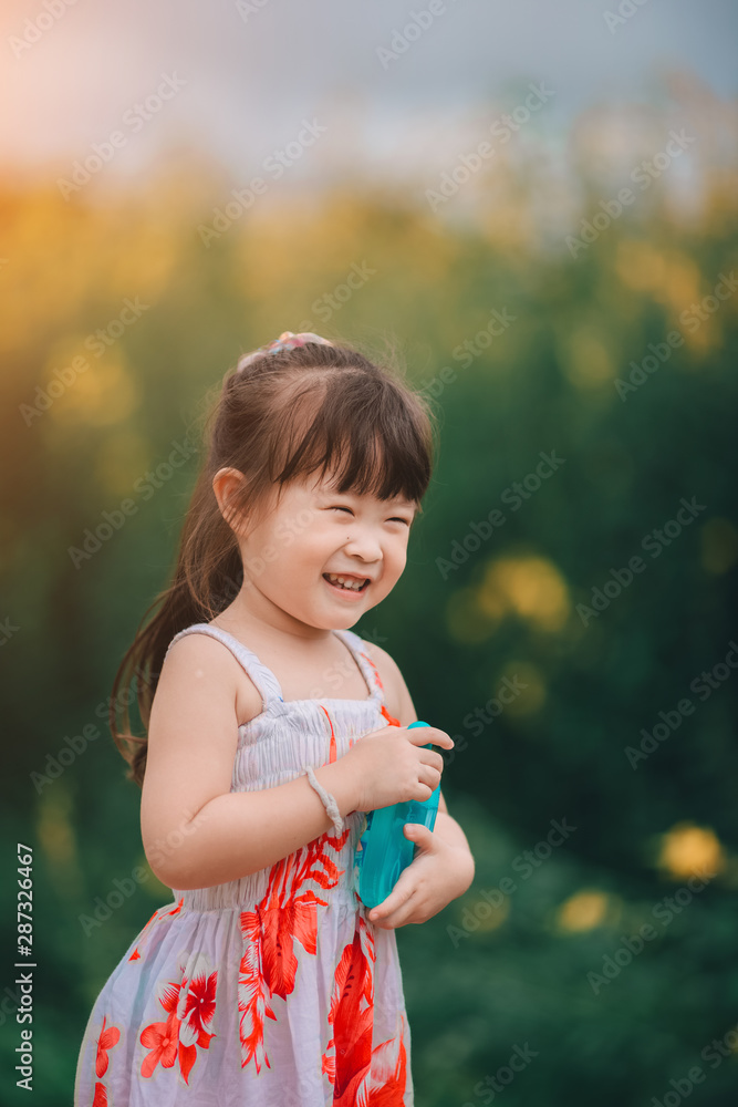 Happy little asian girl in flower field Happy little asian girl in flower field