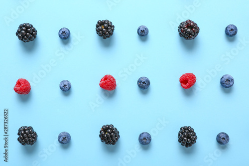 Many sweet ripe berries on color background