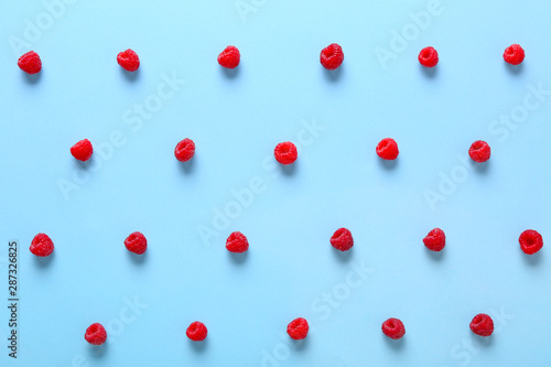 Many sweet ripe raspberry on color background