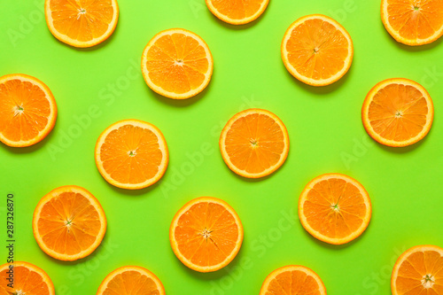 Many orange slices on color background