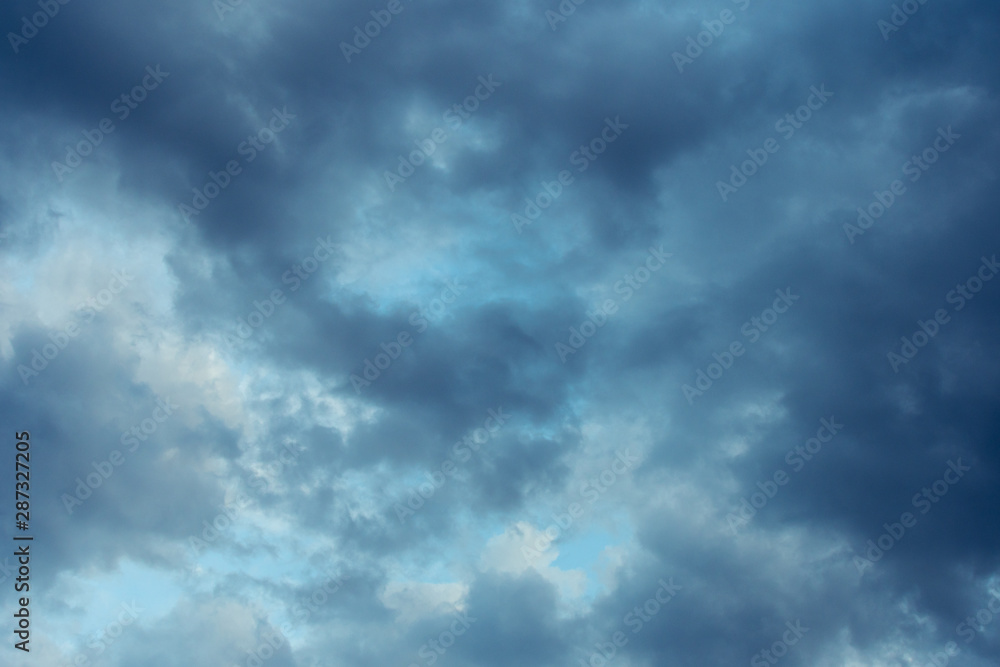 Blue hour sky clouds background. Beautiful landscape with stormy clouds and purple sun on sky