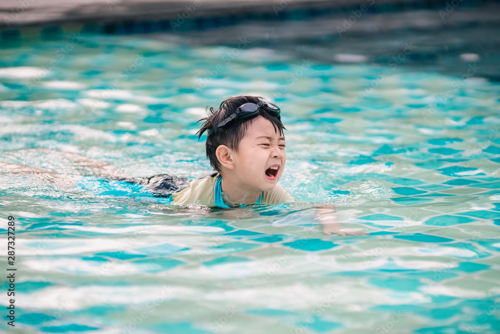 The boy is crying in swimming pool