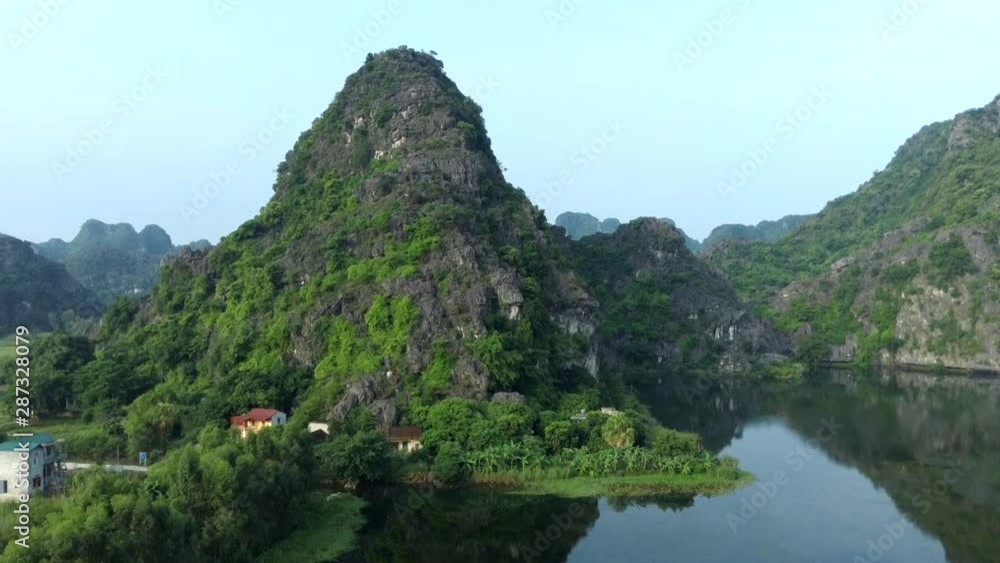 Aerial: Drone flight over Tam Coc, Ninh Binh. Beautful mountain view. Vietnam, Asia. Aerial: Drone flight over Tam Coc, Ninh Binh. Beautful mountain view. Vietnam, Asia.