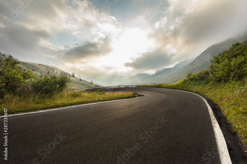 Fototapeta Naklejka Na Ścianę i Meble -  Asphalt road in Dolomites in a summer day, Italy.
