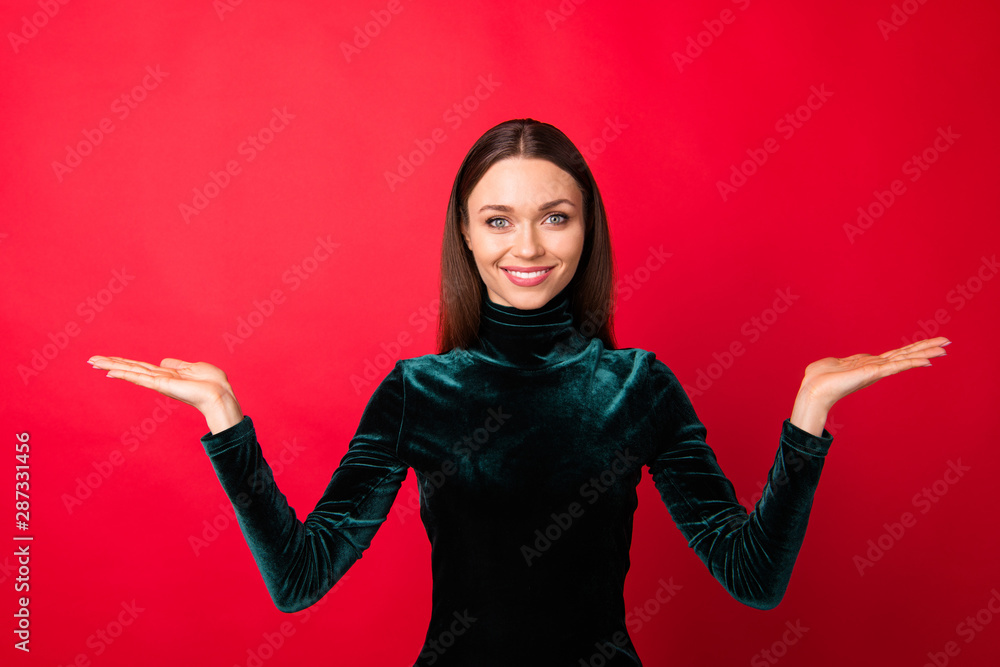 Portrait of pretty charming youth have ads promotion promoter isolated over red background Portrait of pretty charming youth have ads promotion promoter isolated over red background