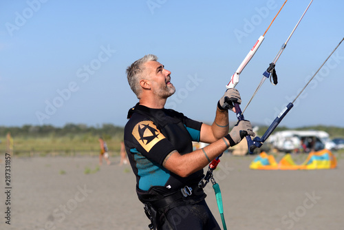 Kite surfer having fun on a beautiful sunny and windy day. Extreme sports and fun. Kitesurfing lessons. Sea and sun. Extreme watersports.