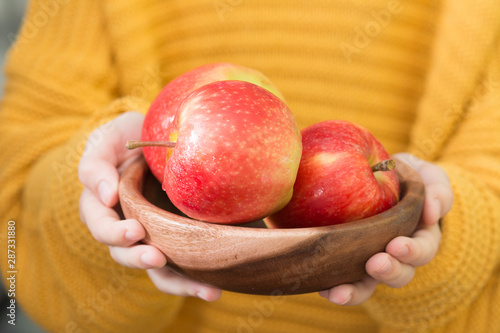 Red apples in children's hands